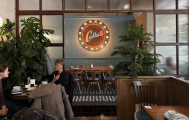 Milk Bar - vibrant interior featuring a neon sign and modern, stylish furniture