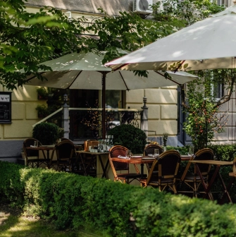 Summer terrace of La Veranda restaurant in Kyiv in the middle of a green garden