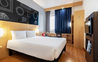 Ibis Railway Station in Kyiv - bedroom with white bed and black chalkboard wall