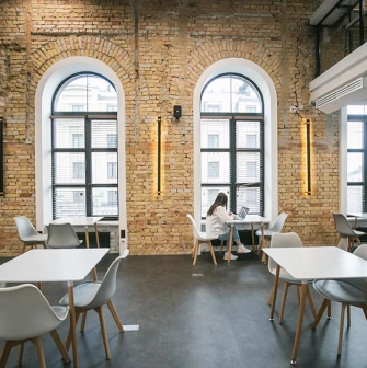 Interior of Peremoga Space in Kyiv with brick walls and large windows