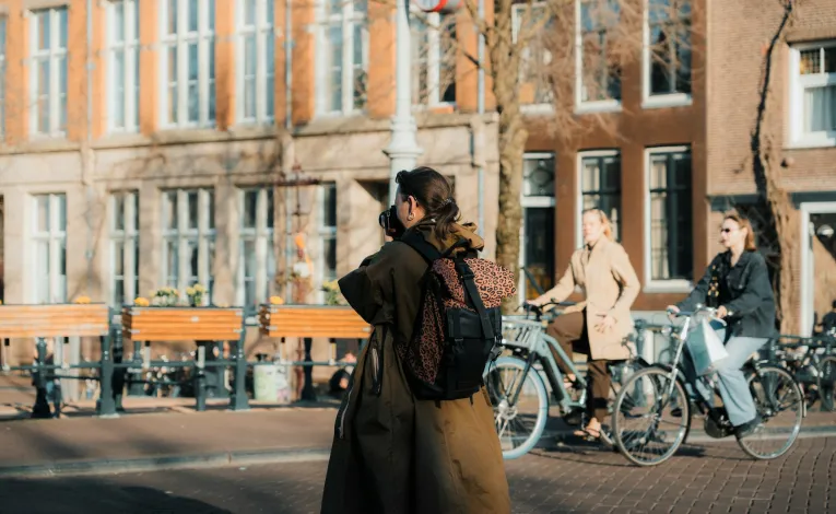 Photographer taking pictures of Kyiv's beautiful urban landscape during golden hour, demonstrating the city's photographic appeal celebrated in local contests