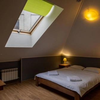Room on the attic floor with a double bed at Dream Hostel in Kyiv