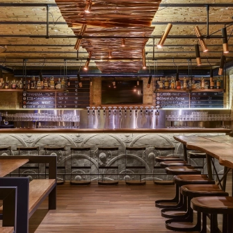 Pub Varvar bar - main bar counter area with numerous beer taps and seating for guests