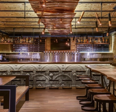 Pub Varvar bar - main bar counter area with numerous beer taps and seating for guests