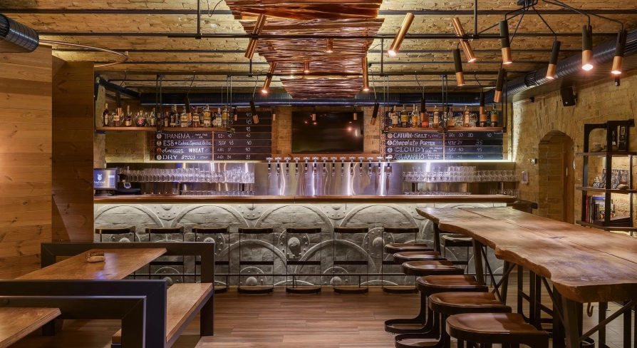 Pub Varvar bar - main bar counter area with numerous beer taps and seating for guests