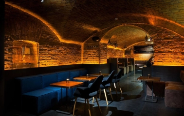 Loggerhead - cozy, dimly lit interior with unique archways and soft wall textures