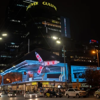 Gulliver shopping center in Kyiv at night with bright lights and a video screen