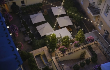 Vozdvyzhenskyi in Kyiv - overhead view of courtyard with white umbrellas and lights