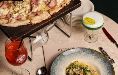By Italy – truffle pasta and mortadella pizza served with Aperol Spritz and signature cocktail