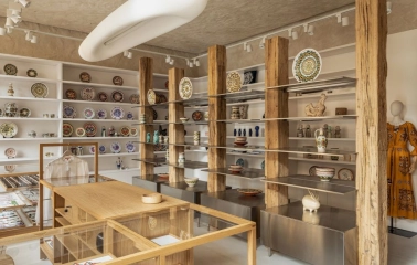 Narodnyi Dim Ukraina in Kyiv - elegant shopping space with wooden beams displaying ceramic plates and traditional clothing