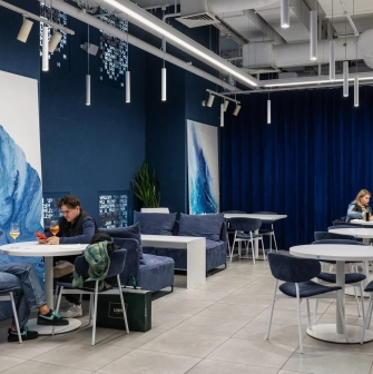 Egersund - brightly lit dining hall with spacious tables and overhead lamps