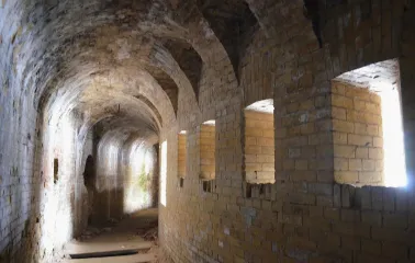 Kyiv Fortress in Kyiv - long curved brick tunnel with light streaming through loopholes