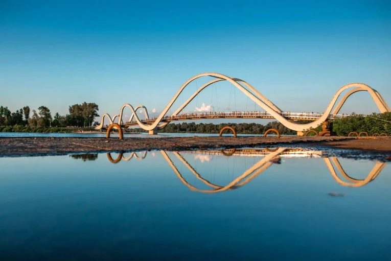 Azov Wave Bridge in Kyiv - white wave-shaped bridge reflecting in the water surface