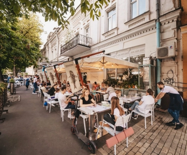 Chornomorka - street terrace with tables and umbrellas
