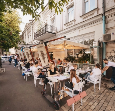Chornomorka - street terrace with tables and umbrellas