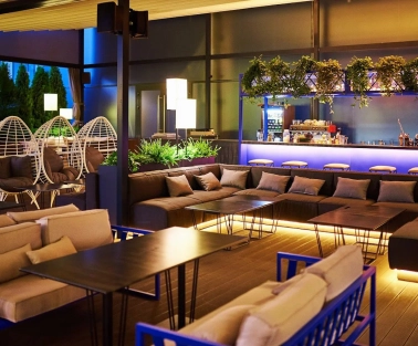 Par Bar - terrace with sofas and hanging chairs near bar counter