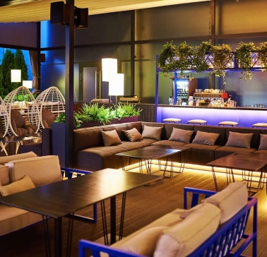 Par Bar - terrace with sofas and hanging chairs near bar counter