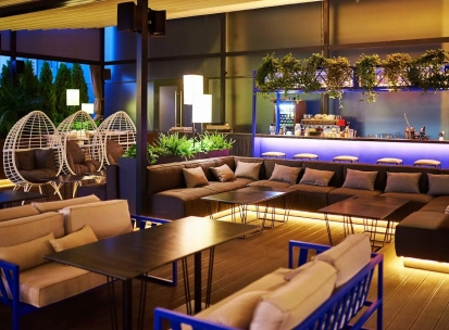 Par Bar - terrace with sofas and hanging chairs near bar counter