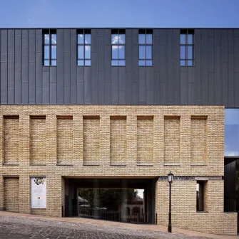 Teatr na Podoli in Kyiv - striking modern architecture of the theater featuring a dark metal upper facade and yellow brick base