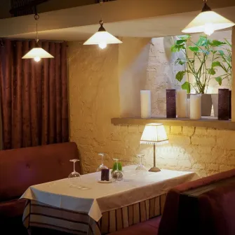 Resraurant Under Wonder - cozy interior with velvet booth seating and dramatic overhead lighting