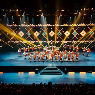 Palats Ukraina in Kyiv - vibrant stage performance by a folk dance ensemble in red costumes