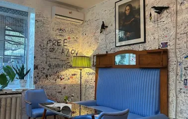 OG Burger in Kyiv - blue sofa and graffiti walls with funny picture