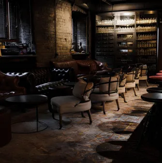 Beatnik Bar - intimate dining tables set with drinks in a cozy corner