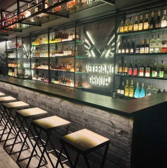 Modern restaurant bar counter with illuminated shelves and bottles