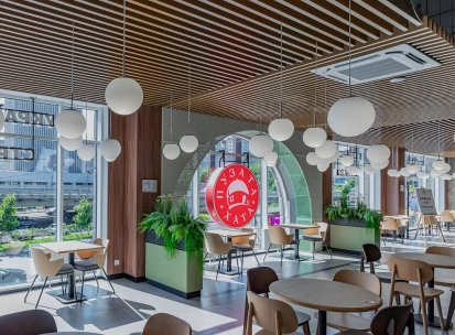 Restaurant Puzata Hata - bright dining area with large windows and the red Puzata Hata logo