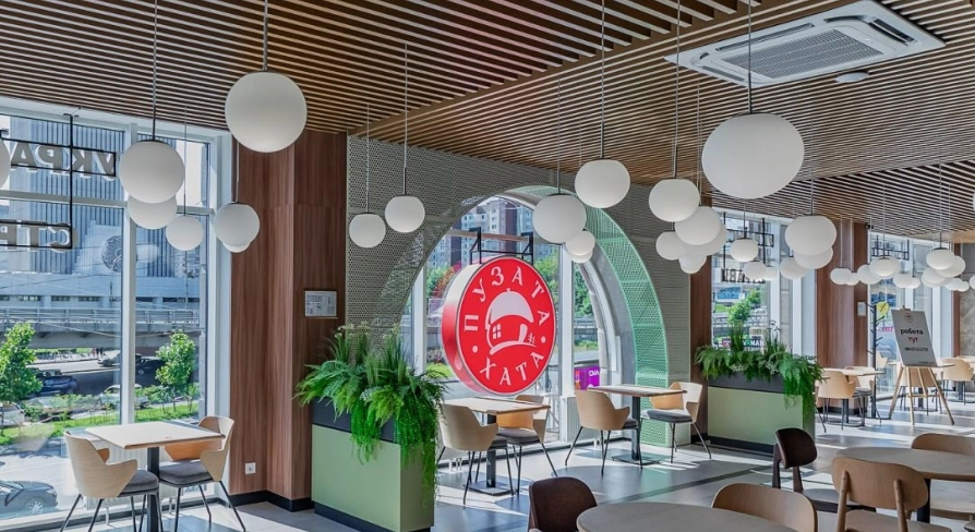 Restaurant Puzata Hata - bright dining area with large windows and the red Puzata Hata logo