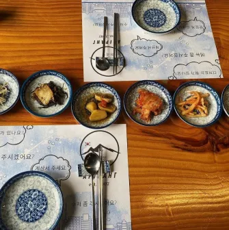 Restaurant Arirang - table set with various Korean appetizers and small bowls