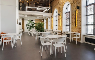 Interior of Peremoga Space in Kyiv with brick walls and large windows