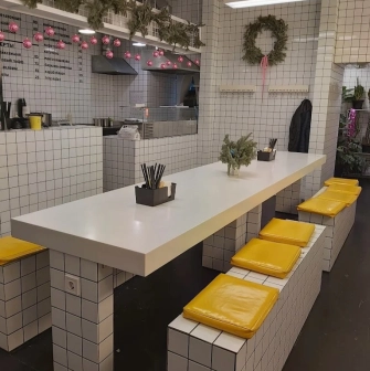 Fruit+Veg Sandwich - minimalist tiled interior with yellow seat cushions