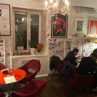 OG Burger in Kyiv - interior with red chairs and graffiti walls