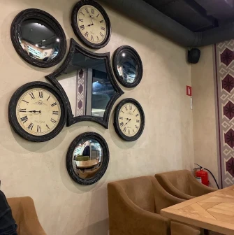 Chachapuri in Kyiv - wall decorated with composition of round clocks and mirrors