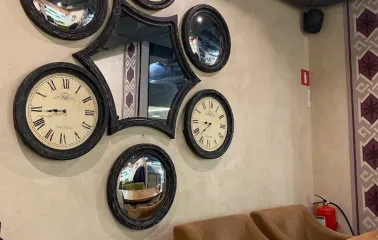 Chachapuri in Kyiv - wall decorated with composition of round clocks and mirrors