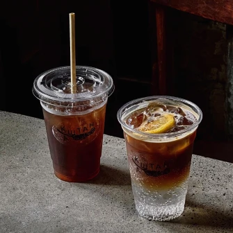Kashtan - two iced drinks beverages in disposable cups on a counter
