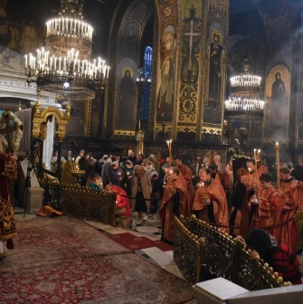 St. Volodymyr's Cathedral in Kyiv - liturgy service with priests in red robes and candles