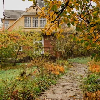Pyrohiv Museum in Kyiv - rural wooden house surrounded by autumn garden