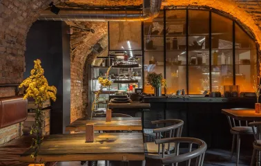 Winbar - long table set for dining with hanging lighting and contemporary artwork