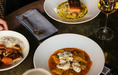 Restaurant Italiiska Redaktsiia - top-down view of pasta salmon and wine on a table