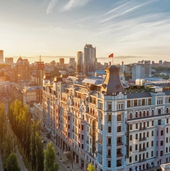 The facade of the Premier Palace Hotel in Kyiv with the Ukrainian flag on the roof