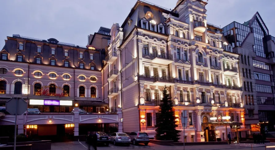Illuminated facade of the Opera Hotel in Kyiv in the evening