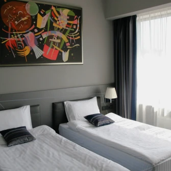 Mercure Congress - bright hotel room interior with a work desk and wall art