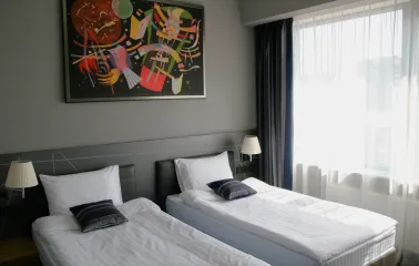 Mercure Congress - bright hotel room interior with a work desk and wall art