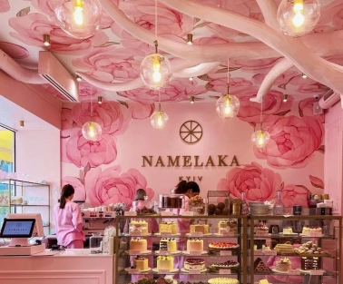 A showcase with cakes in the pink Namelaka coffee shop in Kyiv