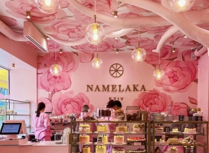 A showcase with cakes in the pink Namelaka coffee shop in Kyiv