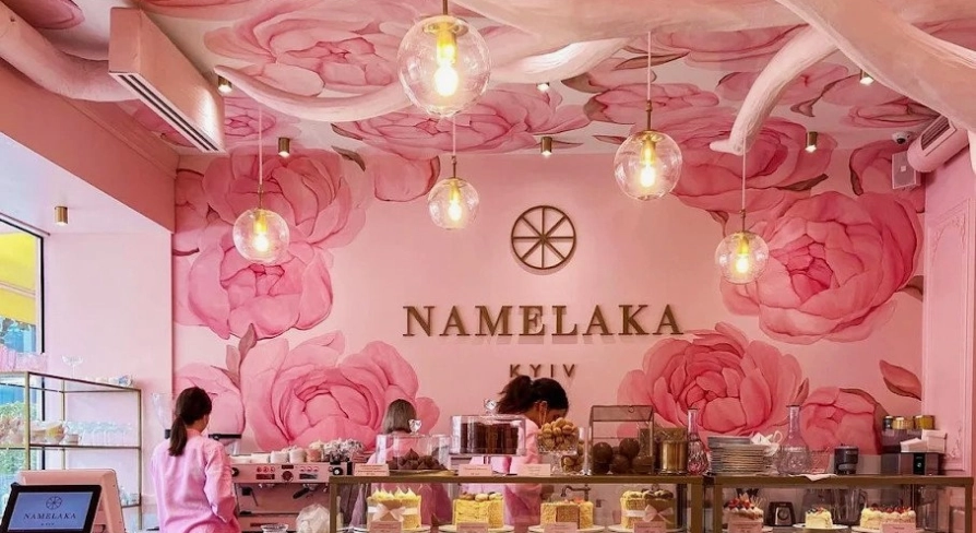 A showcase with cakes in the pink Namelaka coffee shop in Kyiv