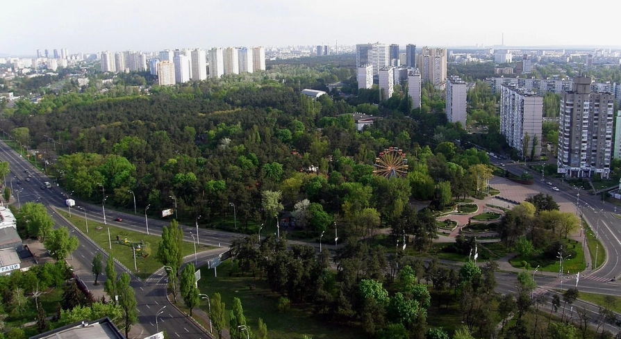 Peremoha Park in Kyiv - aerial view of the green park landscape featuring a Ferris wheel and residential buildings