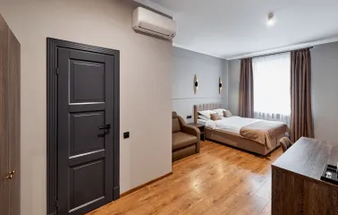 Business-style bedroom in Hotel Classic featuring a comfortable bed and desk